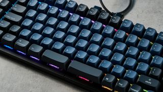 A carbon black Keychron Q11 split ergonomic keyboard