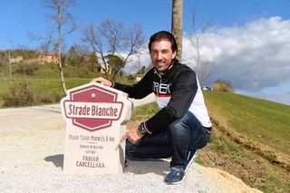 Fabian Cancellara next to the Strade Bianche milestone dedicated in his honor