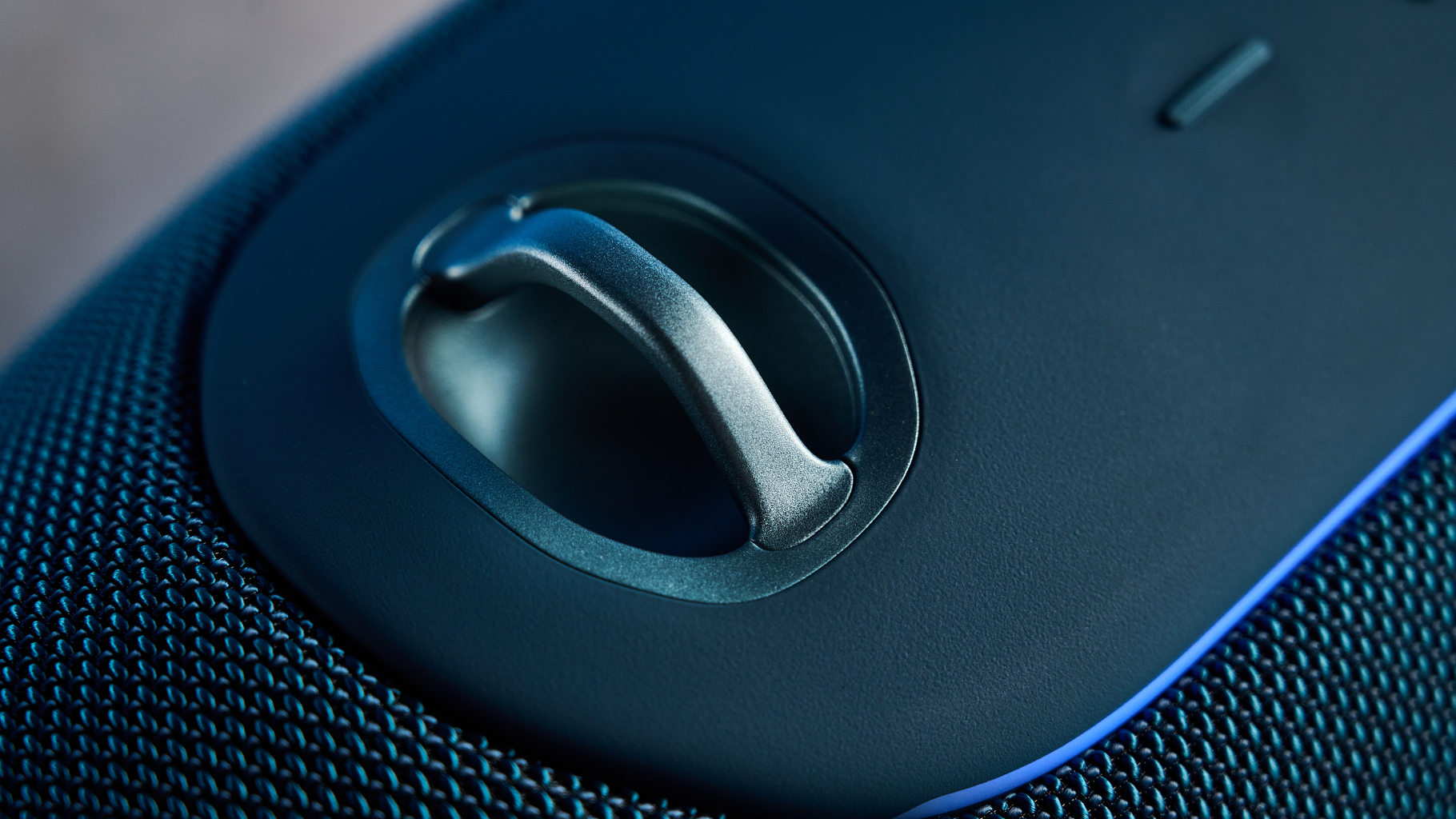 the JBL Xtreme 5 bluetooth speaker in blue shown with the rugged carry strap and buttons
