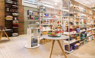 Hay's Mini Market at the MoMA Design Store. A store with rows of shelving with various products on them.
