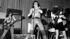 (from left) AC/DC's Malcolm Young, Bon Scott, and Angus Young perform onstage in 1976