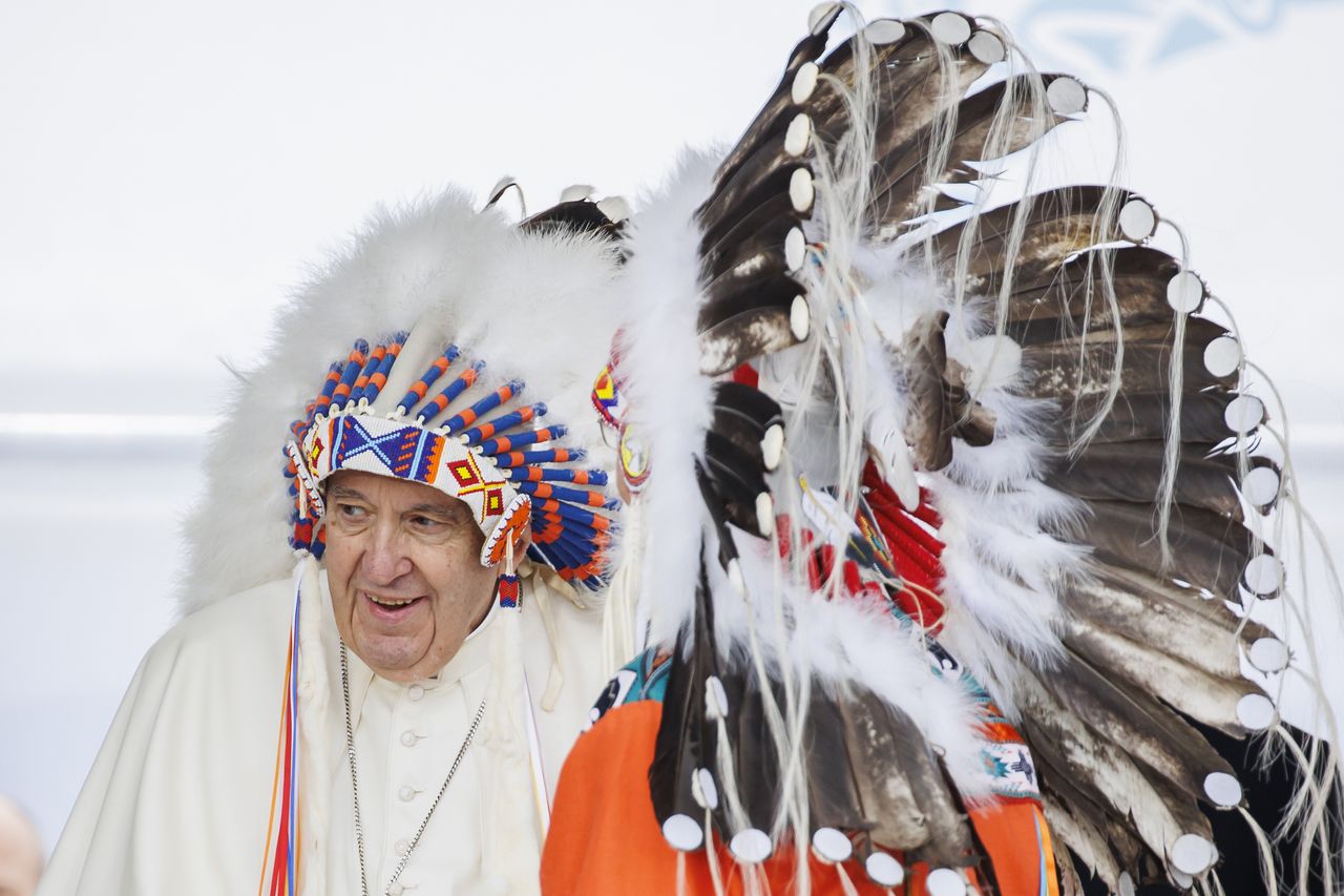 Pope Francis wears a traditional headdress gifted to him Indigenous leaders