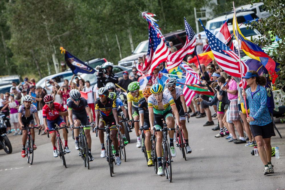 Fans cheer as the lead group nears the top of the climb