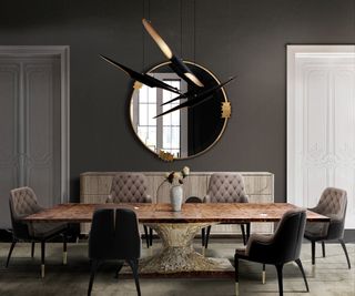 luxurious dining room with large circular mirror and statement pendant light