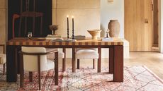 A striped marquetry table in the middle of a living room designed by Soho Home