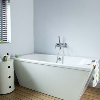 bathroom with white walls and bathtub