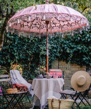 Pink parasol with outdoor dining area