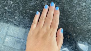 hand with blue nail polish