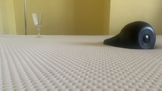Image shows an 8kg weight placed near a wine glass during review of the Emma Original mattress