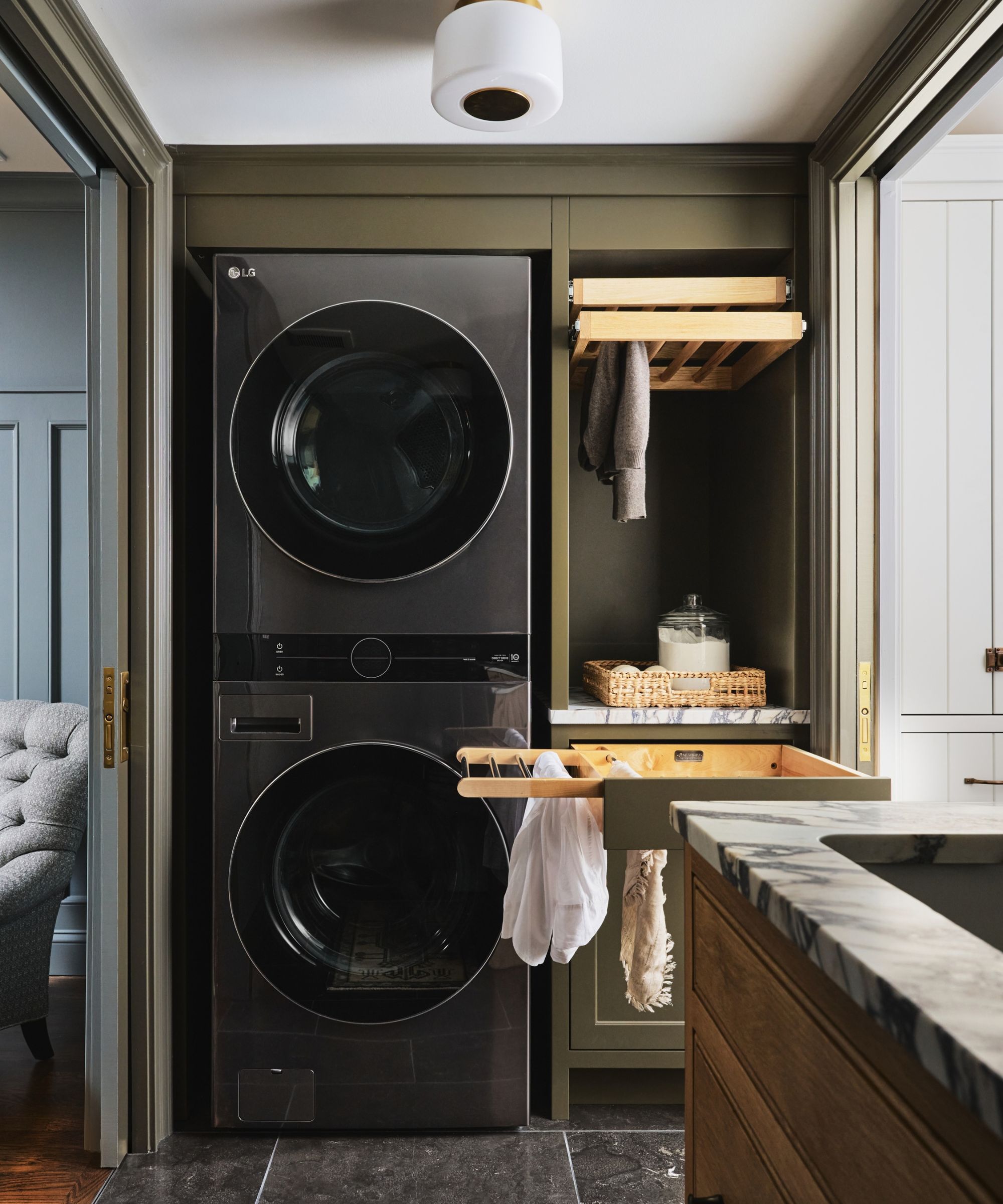 Laundry in a closet with pull out drying racks