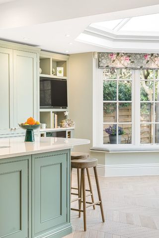 green kitchen island in bright kitchen