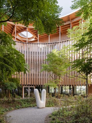 Herzog & de Meuron Children's Hospital in Zurich timber building interior and exterior engulfed in foliage