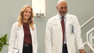 Kim Raver and James Pickens Jr. as Teddy and Richard smiling at the hospital in Grey's Anatomy season 19