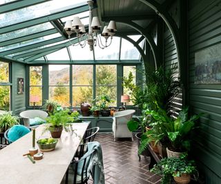 green garden room painted in farrow and ball with long large dining table