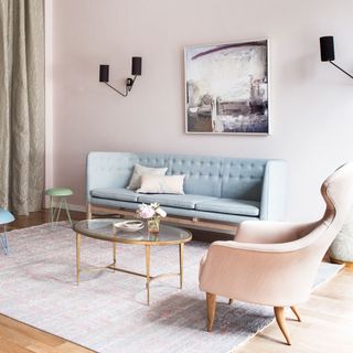living room with pastel furniture and wooden flooring