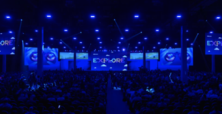 VMware Explore 2023 conference keynote stage lit in blue light.