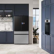 a kitchen with navy blue fitted cabinets and a Samsung fridge freezer and built in oven