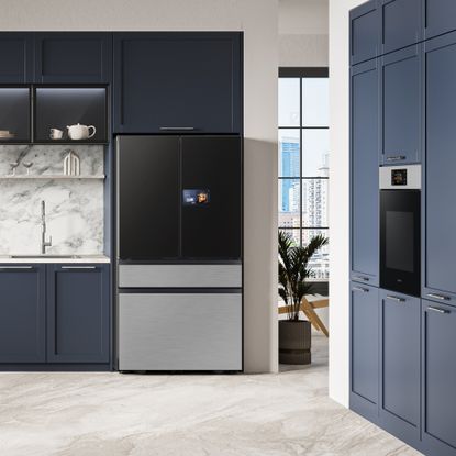 a kitchen with navy blue fitted cabinets and a Samsung fridge freezer and built in oven