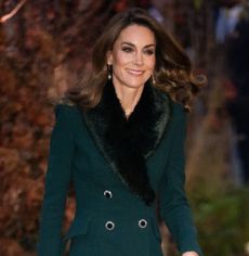 Kate Middleton wearing a green fur trimmed coat