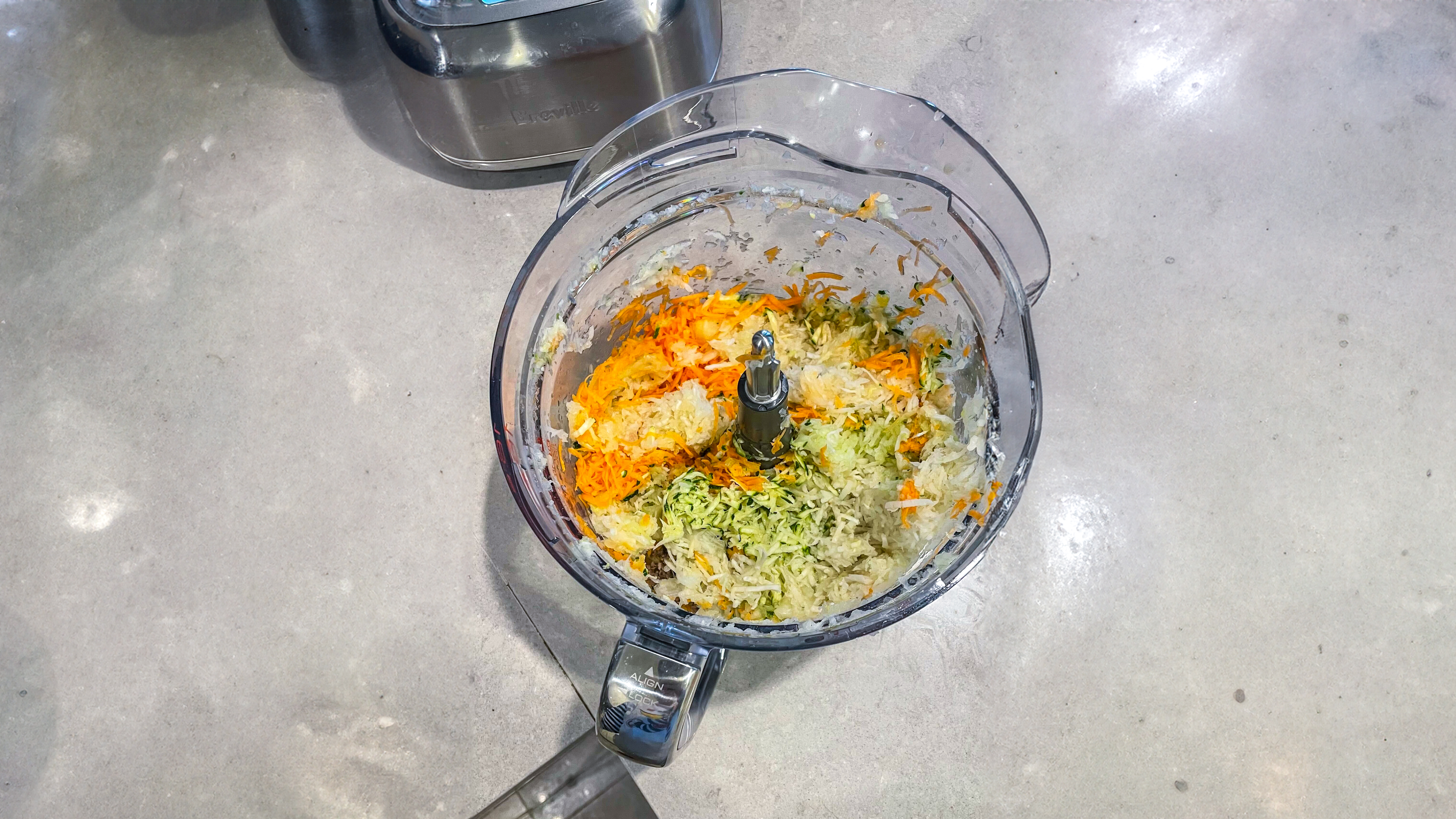 Grated mixed vegetables inside the bowl of the Breville Paradice 16