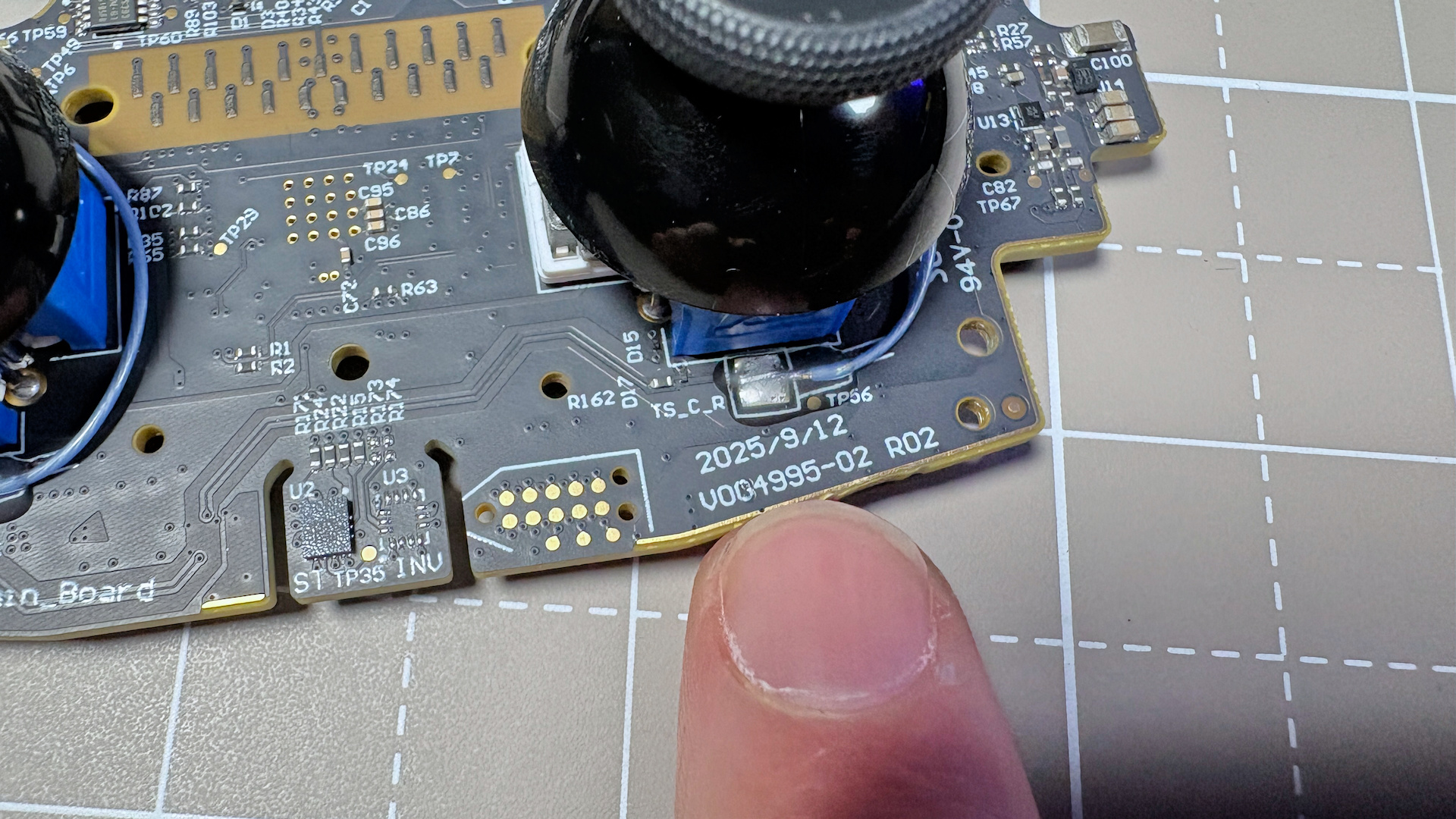 The Steam Controller on a desk during a teardown, with various parts removed.