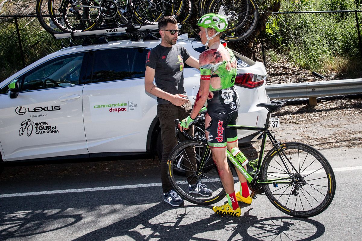 Cannondale-Drapac sports director Tom Southam assesses Toms Skujins after his high speed crash