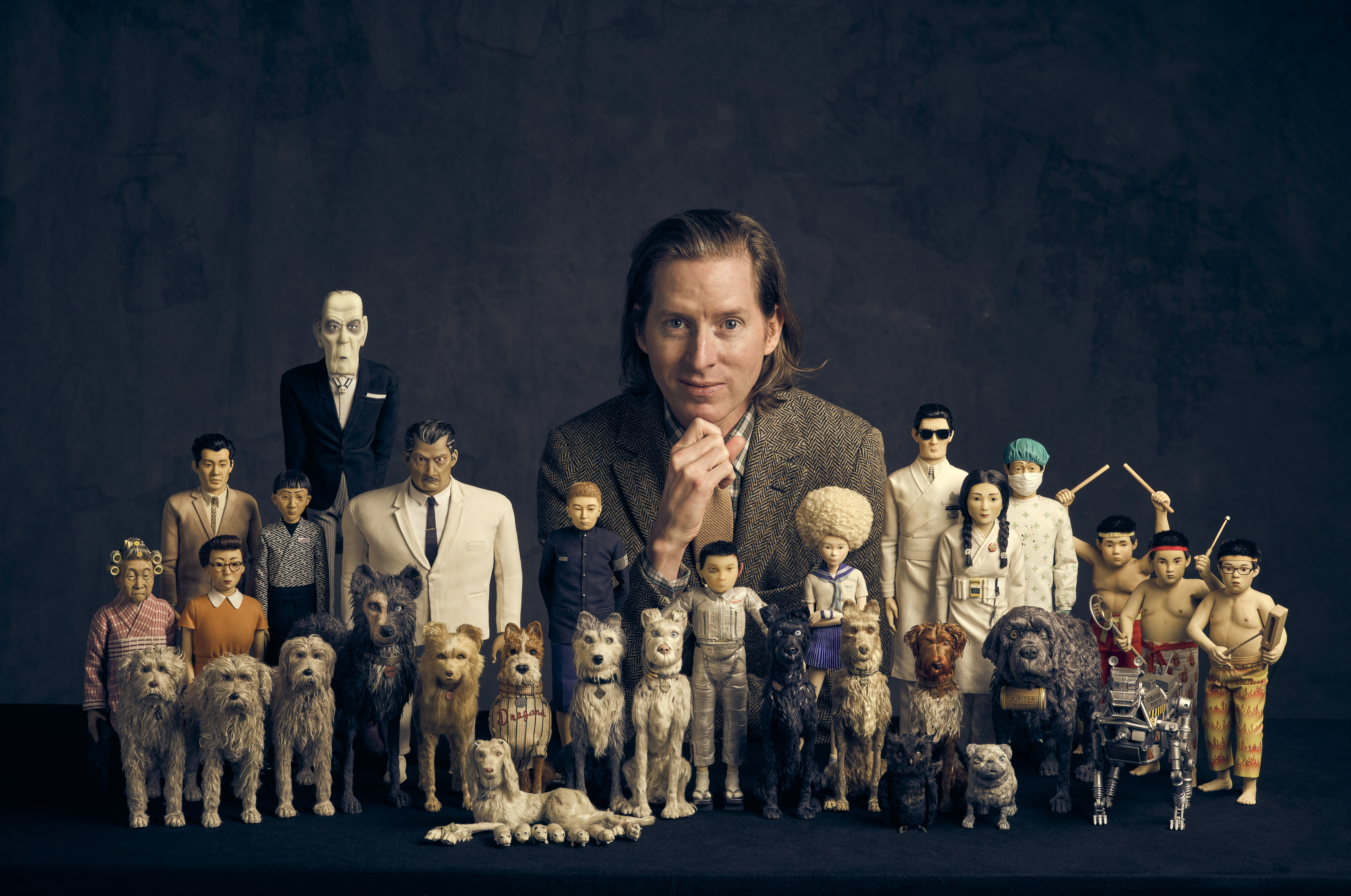 Wes Anderson behind a display of character models