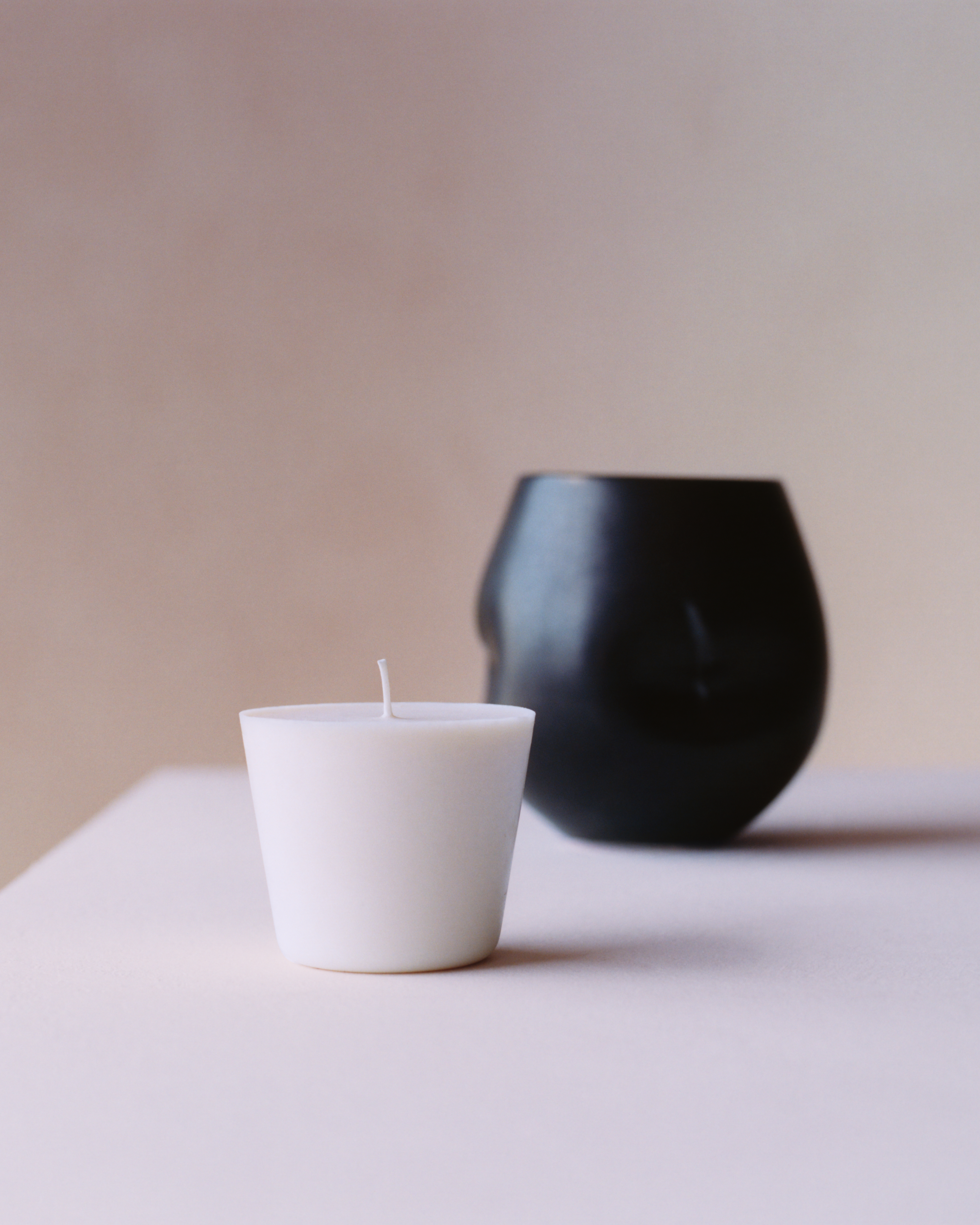 Candle by Tekla, with a vessel that looks like it was pinched on one side