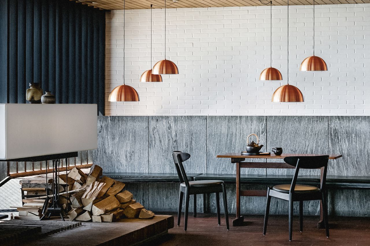 Seating area with table, chairs and logs on the side