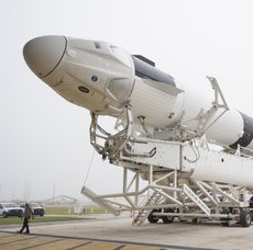 A SpaceX Falcon 9 rocket with the company's Crew Dragon spacecraft onboard is seen as it is rolled out of the horizontal integration facility at Launch Complex 39A as preparations continue fo