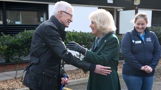 Camilla, Duchess of Cornwall, patron of Battersea Dogs and Cats Home, is greeted by Battersea Ambassador Paul O’Grady