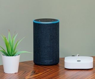 Yale smart alarm on table with Amazon Echo speaker