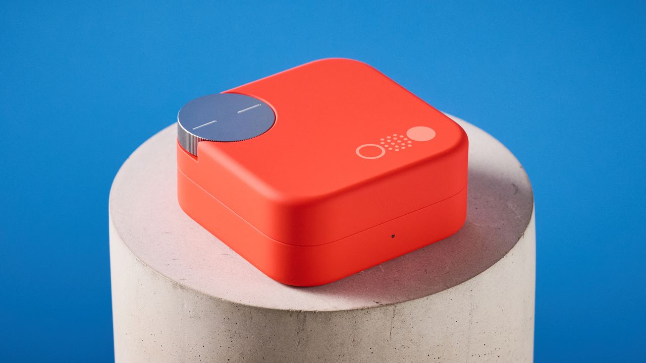 the nothing cmf buds pro 2 cmf by nothing buds pro 2 in bright orange shown in the smart dial charging case against a blue tom's guide background