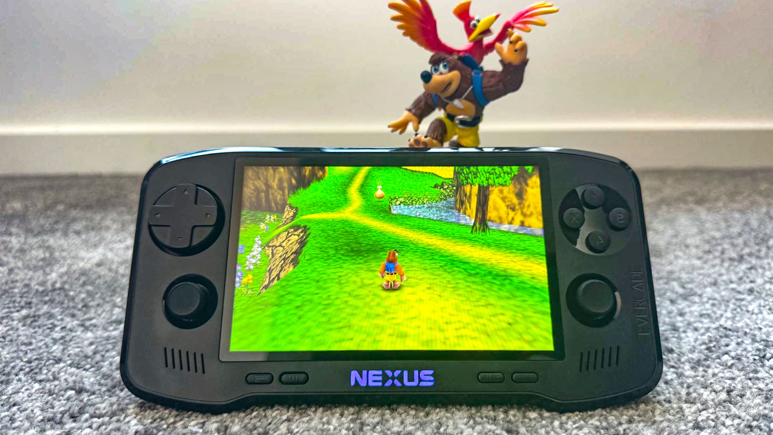 Evercade Nexus playing Banjo-Kazooie next to a Banjo-Kazooie figurine