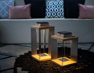 Stainless steel solar lanterns on an outdoor table