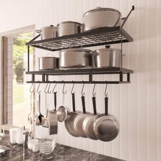 black wire kitchen shelves and hooks with stainless steel pots and pans