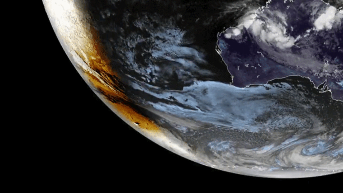 The shadow of the moon is visible over Earth's southern surface to the left of the line separating night from day.