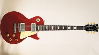 Studio still life of a 1957 Gibson Les Paul Standard guitar in cherry finish, nicknamed 'Lucy' and owned by George Harrison it was given to him by Eric Clapton in 1968, photographed in the United Kingdom.