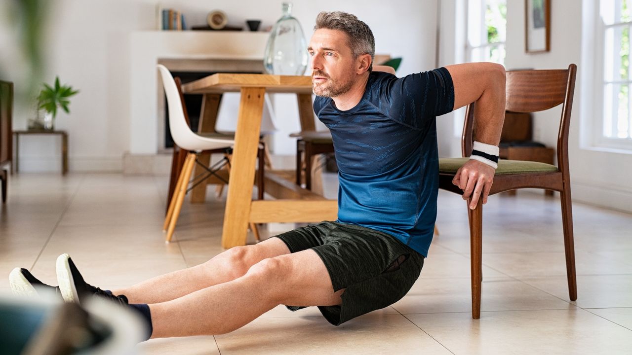 Man doing tricep dips on chair