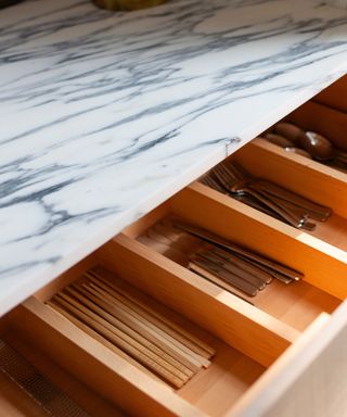 A drawer with organized compartments for silverware