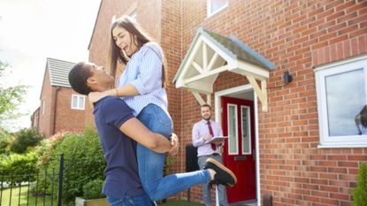 homeowners celebrating buying their first home