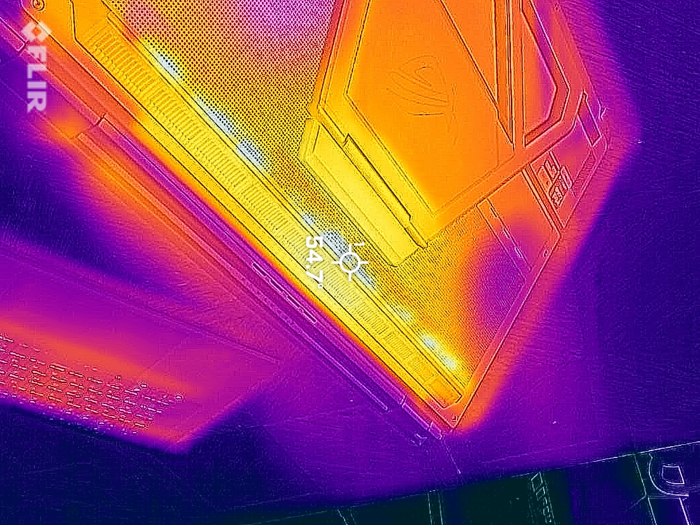 Thermal image of a gaming laptop, showing heat distribution. Bright orange and yellow indicate hot areas, while purple shows cooler spots.