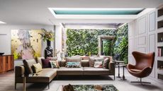 A modern basement with a living wall and a skylight