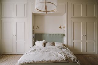 A bed with fitted storage above the headboard