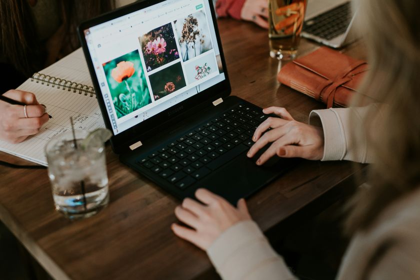 Stock photographs of people smiling and looking at laptops in a small business environment.