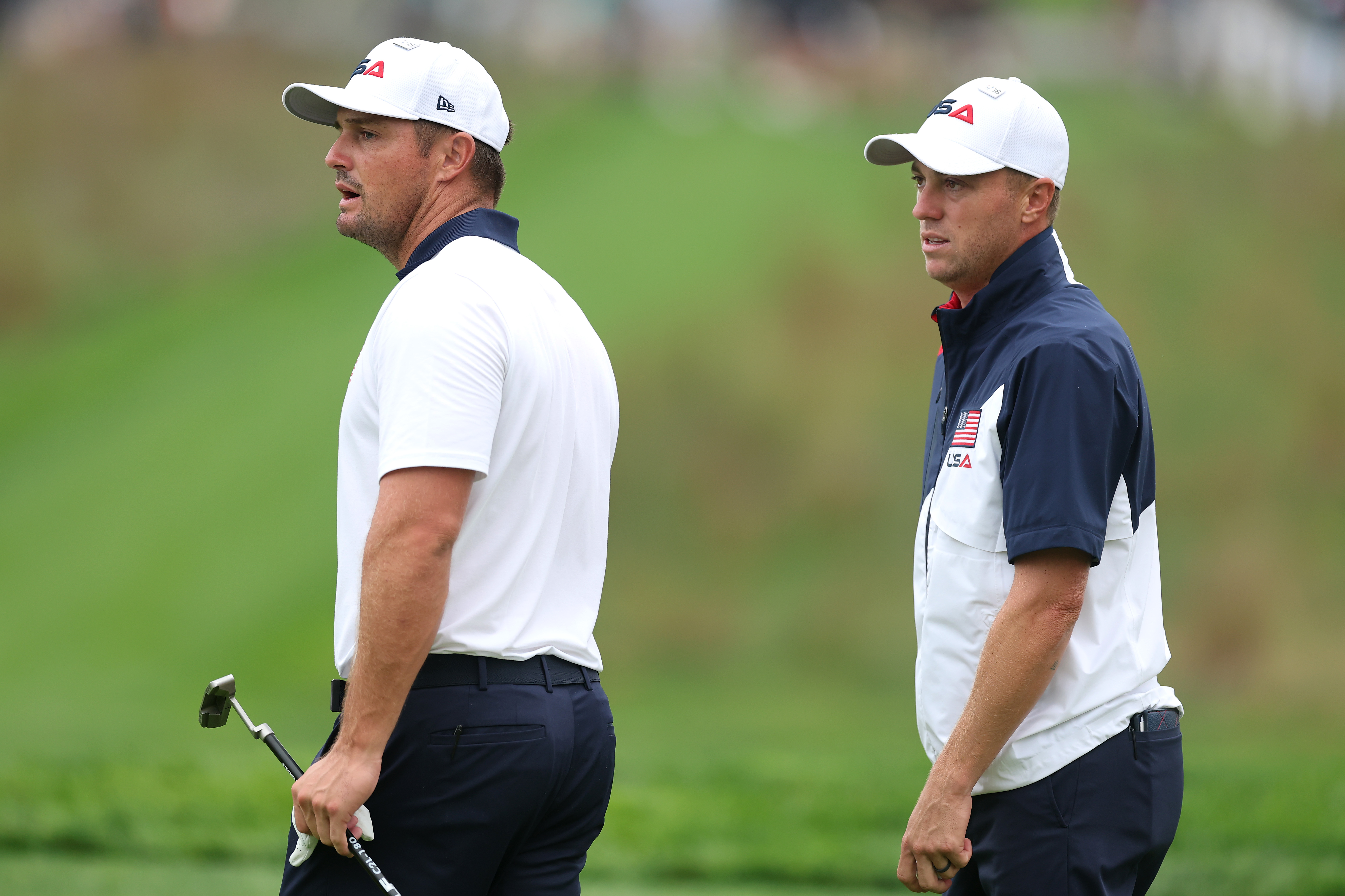 Bryson DeChambeau and Justin Thomas wait on the green