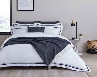 white bedding with grey throw