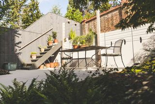 sloping garden ideas: sunken patio area in a sloping garden