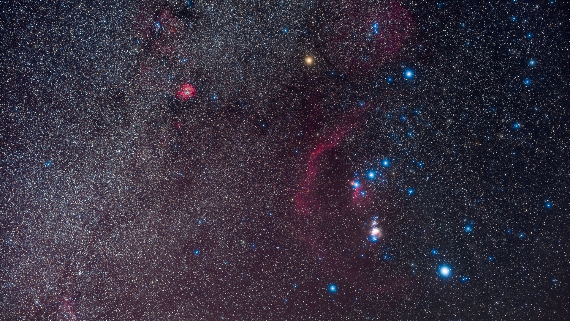 A starry night sky glows pink with blue balls of light dot the right side of the image