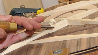 Guitar luthier adjusting brace